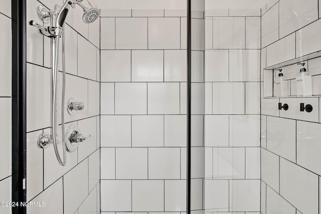 bathroom with tiled shower