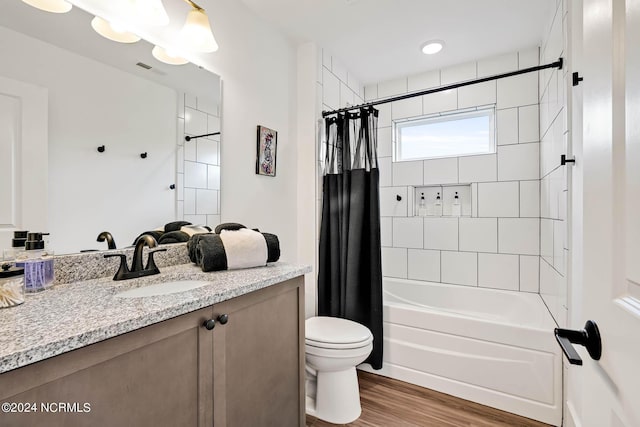 full bathroom with vanity, wood-type flooring, toilet, and shower / bath combo