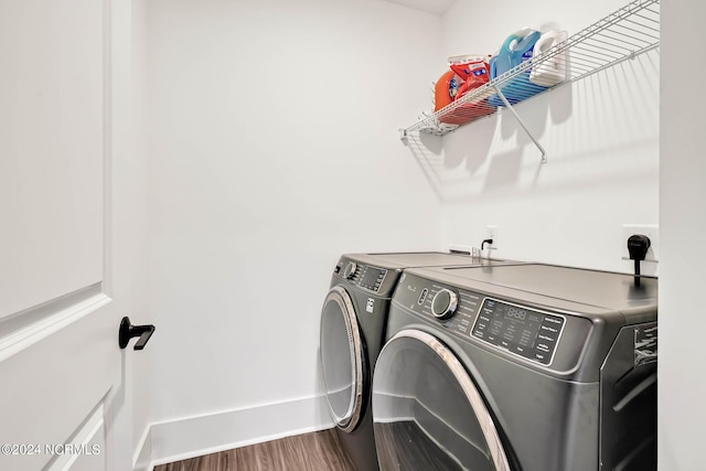 laundry room featuring hardwood / wood-style flooring and washer and clothes dryer