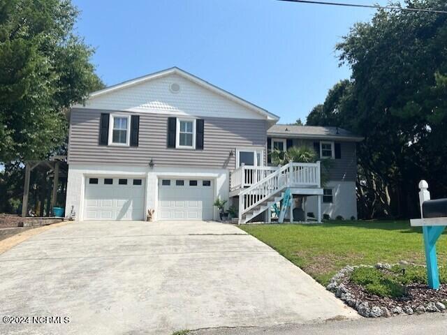 view of front of house with a garage and a front yard