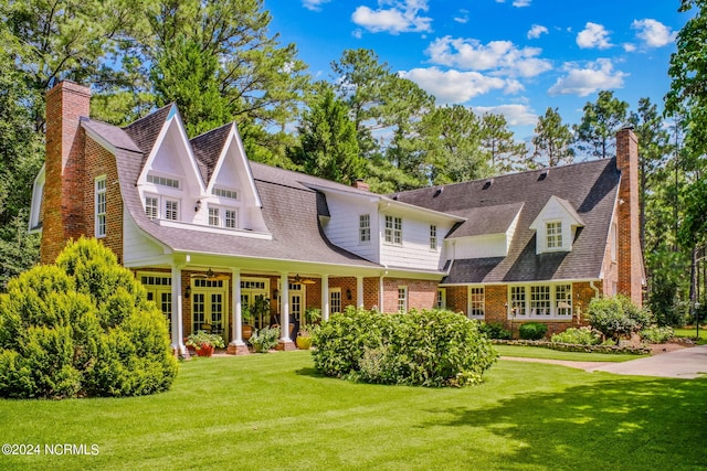 rear view of property featuring a yard