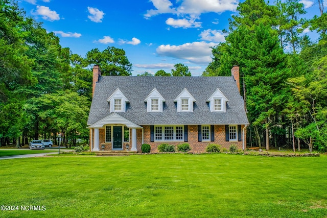 new england style home with a front lawn