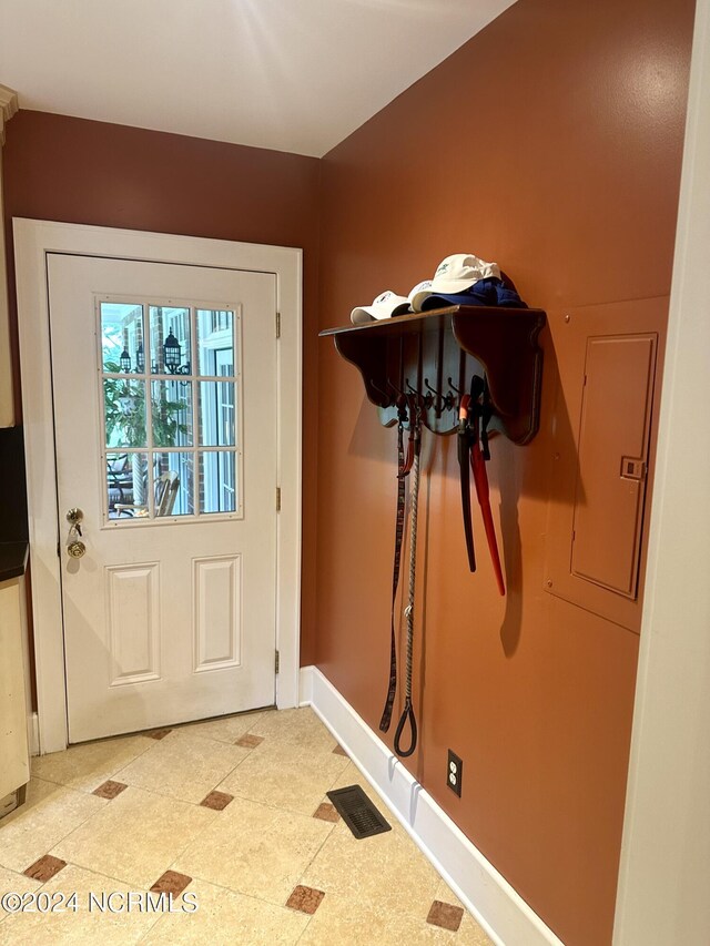 hallway with wood-type flooring and ornamental molding