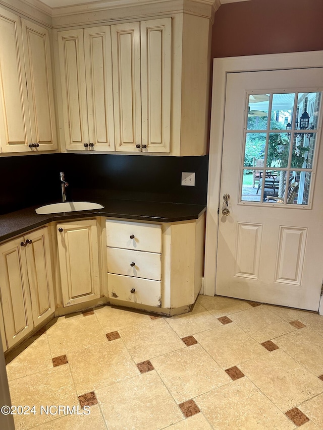 kitchen featuring cream cabinets and sink