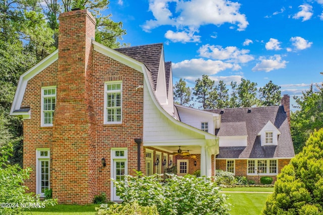 back of house with a yard and ceiling fan