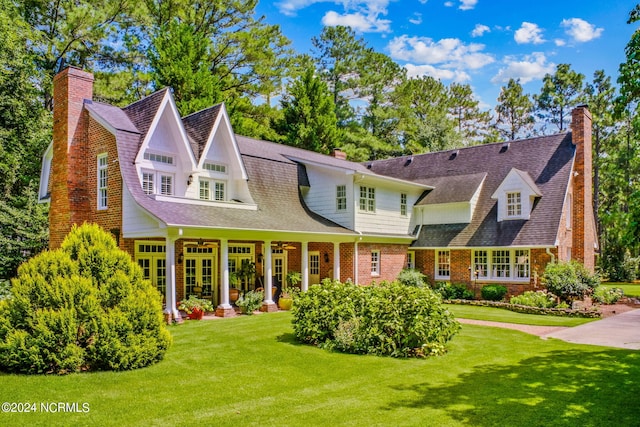 rear view of house featuring a lawn