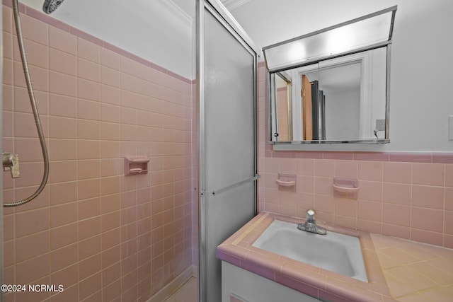 bathroom featuring tile walls, vanity, and a shower