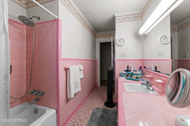 bathroom with crown molding, tile walls, tiled shower / bath combo, vanity, and tile patterned floors