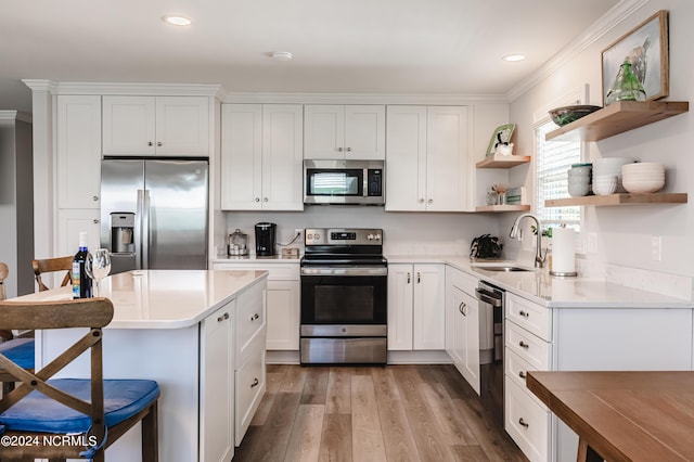 1409 Inlet St, Sunset Beach, NC 28468 - kitchen with appliances with stainless steel finishes, open shelves, ornamental molding, a sink, and white cabinets