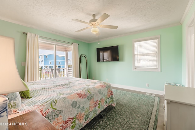 1409 Inlet St, Sunset Beach, NC 28468 - bedroom featuring access to outside, baseboards, wood finished floors, a textured ceiling, and crown molding
