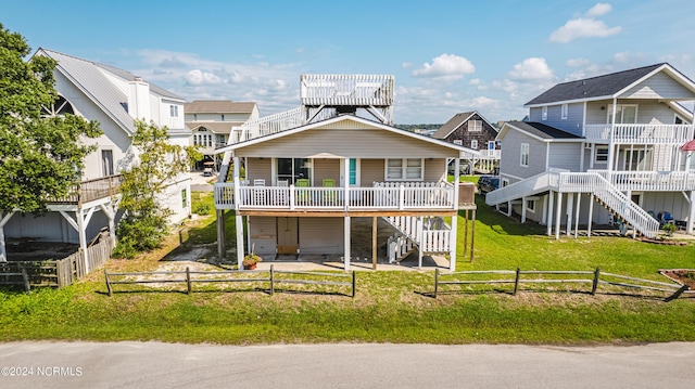 1409 Inlet St, Sunset Beach, NC 28468 - coastal inspired home featuring stairway, a deck, a patio, and a residential view
