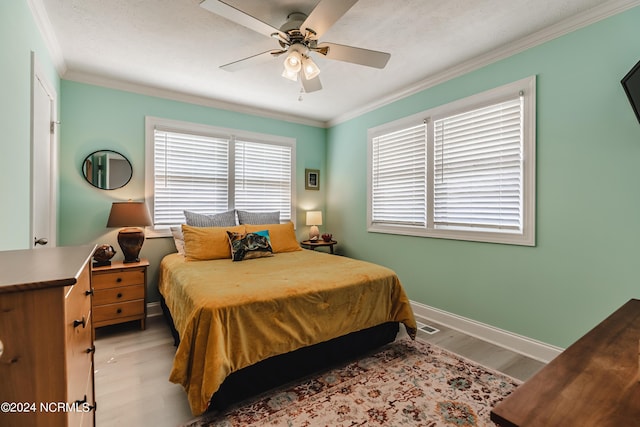1409 Inlet St, Sunset Beach, NC 28468 - bedroom featuring light wood-type flooring, crown molding, baseboards, and a ceiling fan