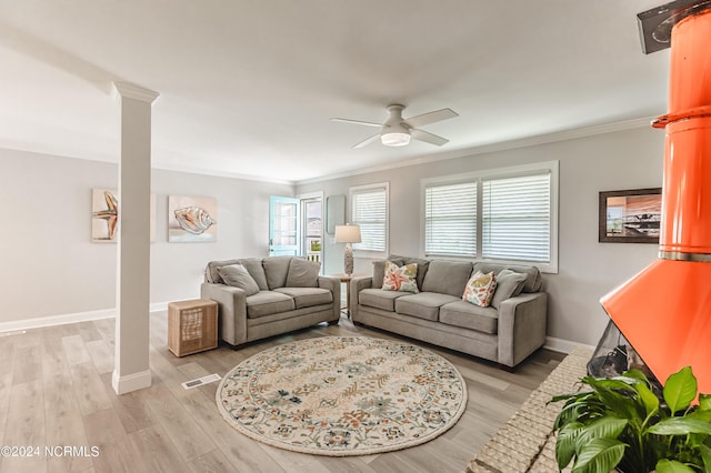 1409 Inlet St, Sunset Beach, NC 28468 - living room featuring ornamental molding, decorative columns, a ceiling fan, light wood-style floors, and baseboards