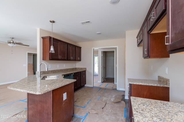 kitchen featuring sink, hanging light fixtures, a kitchen breakfast bar, light stone countertops, and kitchen peninsula