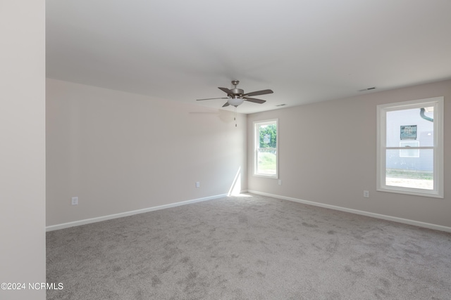 carpeted spare room with ceiling fan