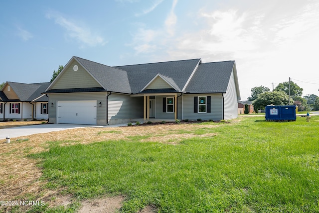 view of front of house with a garage and a front lawn