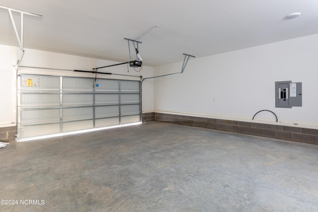 garage with a garage door opener and electric panel