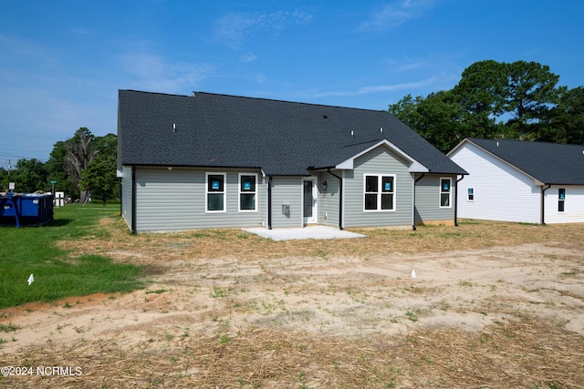 back of property featuring a yard and a patio