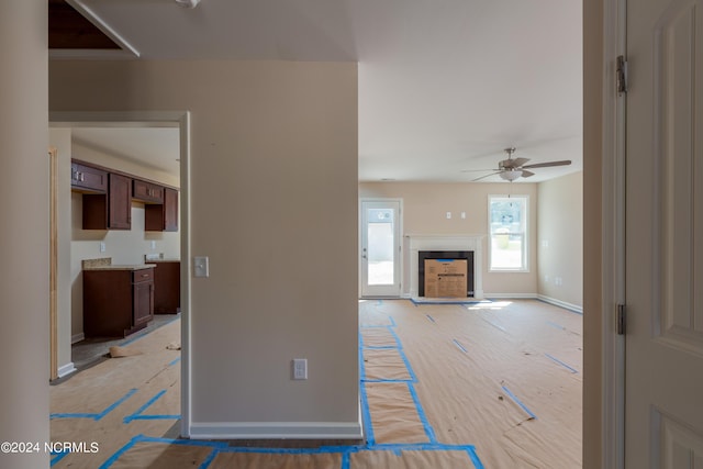 unfurnished living room with ceiling fan