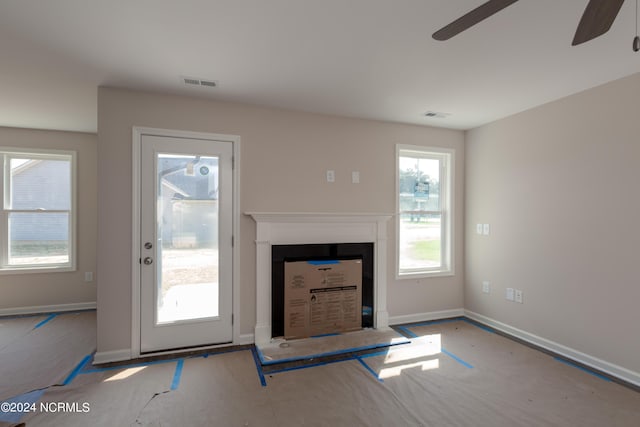 unfurnished living room featuring ceiling fan