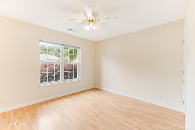 spare room featuring ceiling fan and light hardwood / wood-style flooring