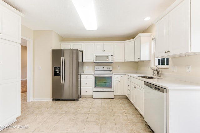 kitchen with white cabinetry, white appliances, sink, and light tile patterned floors