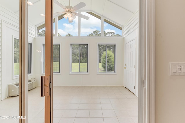 unfurnished sunroom with vaulted ceiling, an AC wall unit, and ceiling fan