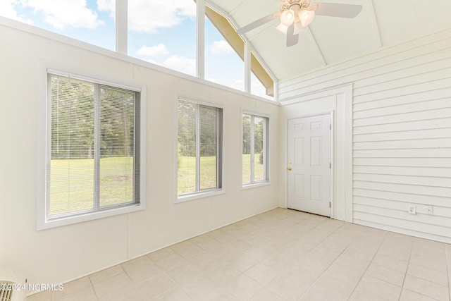 unfurnished sunroom with ceiling fan and vaulted ceiling