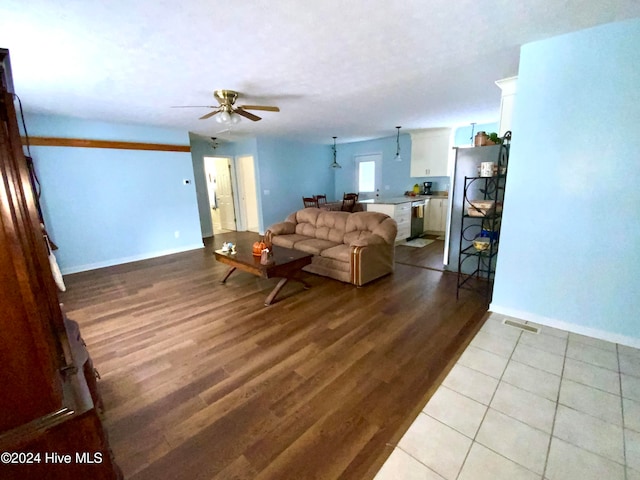 living room with light wood-type flooring and ceiling fan