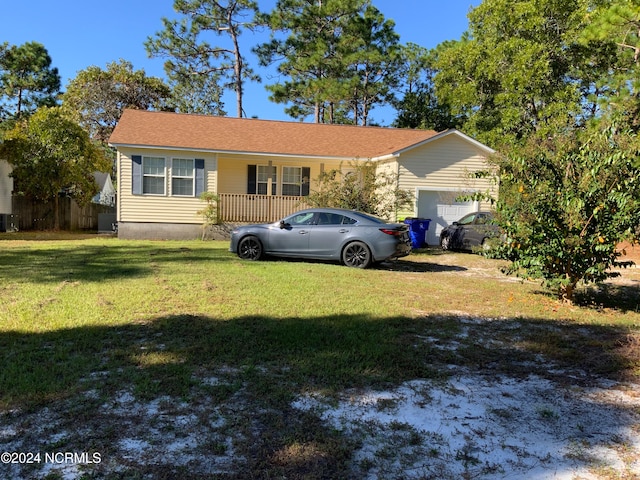 single story home with a front yard and a garage