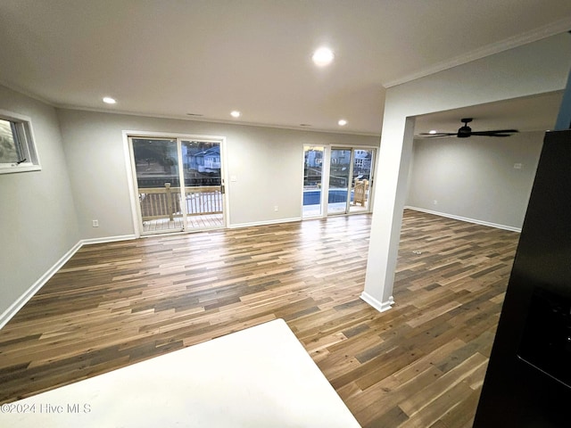 interior space with ceiling fan, ornamental molding, and dark hardwood / wood-style flooring