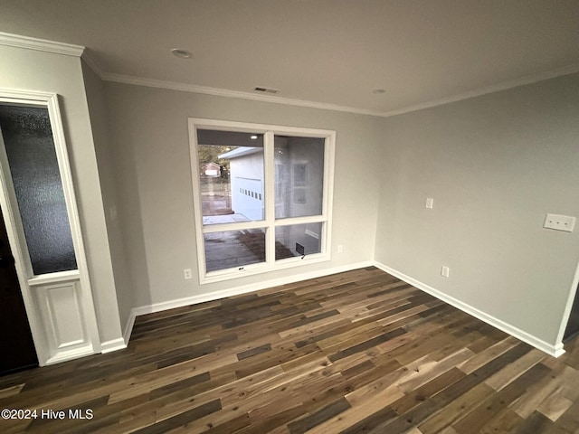 unfurnished living room with dark hardwood / wood-style flooring and ornamental molding