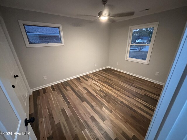 unfurnished room with ceiling fan and dark hardwood / wood-style floors