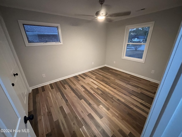 empty room featuring dark hardwood / wood-style floors and ceiling fan