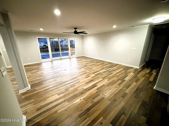 spare room with dark hardwood / wood-style floors, ceiling fan, and crown molding