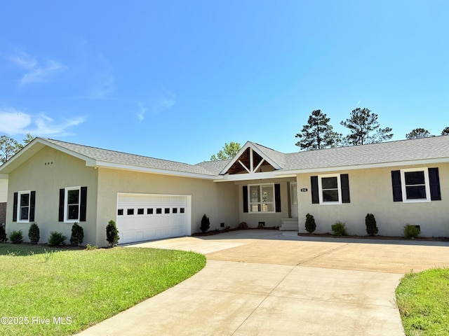 116 Sailors Ct, New Bern, NC 28562 - ranch-style home with driveway, a front yard, an attached garage, stucco siding, and a shingled roof