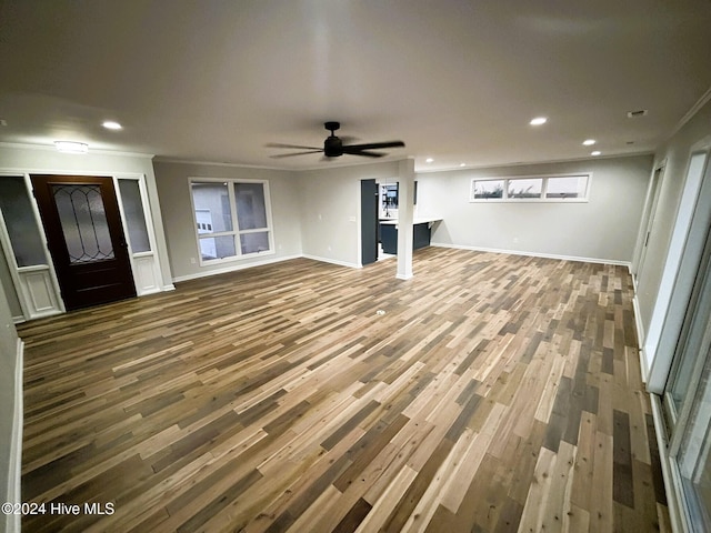 unfurnished living room featuring crown molding, ceiling fan, and hardwood / wood-style floors