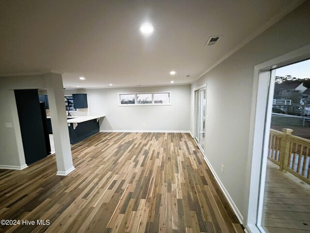 interior space featuring dark hardwood / wood-style floors, ceiling fan, and crown molding