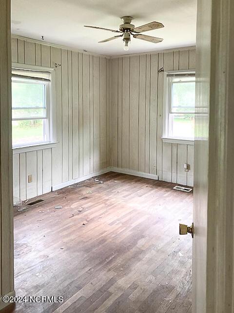 165 Polly Hill Rd, Marshallberg, NC 28553 - empty room with hardwood / wood-style floors, ceiling fan, and wood walls