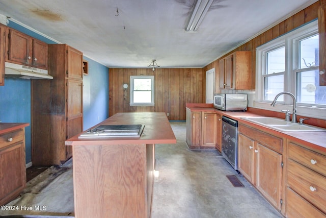 165 Polly Hill Rd, Marshallberg, NC 28553 - kitchen with a sink, under cabinet range hood, appliances with stainless steel finishes, wooden walls, and brown cabinetry