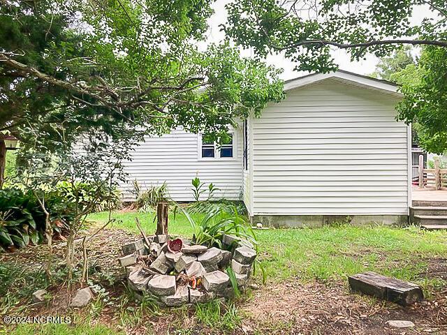 165 Polly Hill Rd, Marshallberg, NC 28553 - view of side of home with a deck and an outdoor fire pit