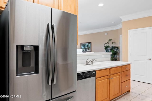 kitchen featuring sink, ornamental molding, appliances with stainless steel finishes, and light tile patterned floors