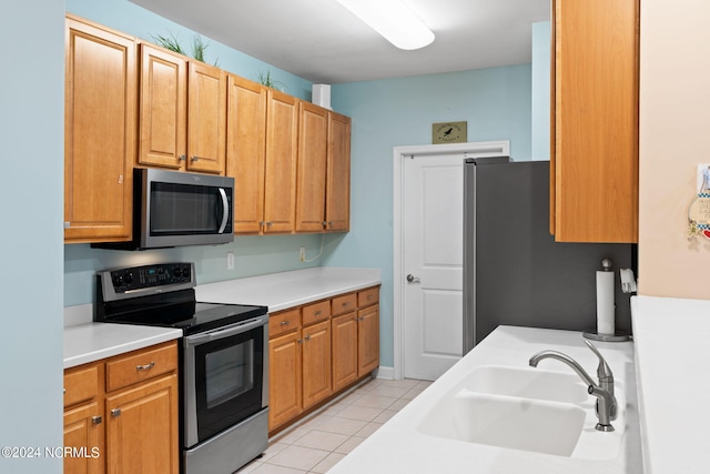 kitchen featuring light tile patterned floors, sink, and stainless steel appliances