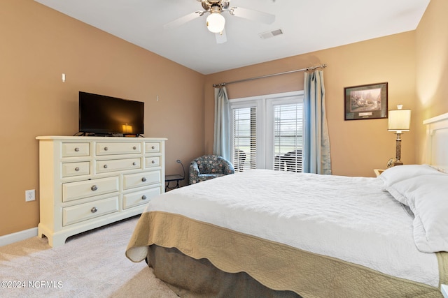 bedroom with light carpet and ceiling fan