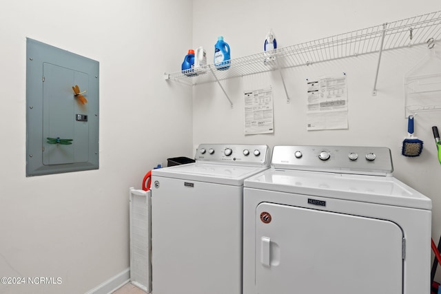 washroom featuring electric panel and washing machine and clothes dryer