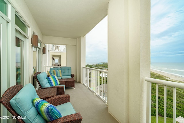 balcony featuring a water view and a view of the beach