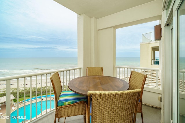 balcony with a water view and a beach view