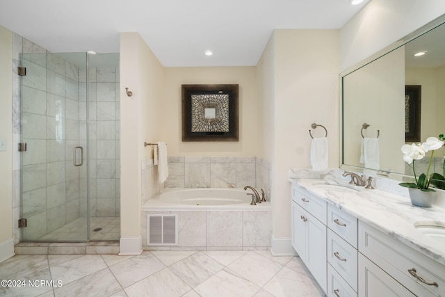 bathroom with vanity and shower with separate bathtub