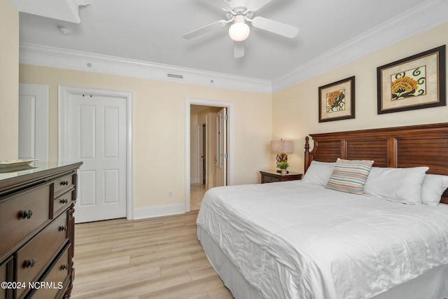 bedroom with crown molding, light hardwood / wood-style floors, and ceiling fan