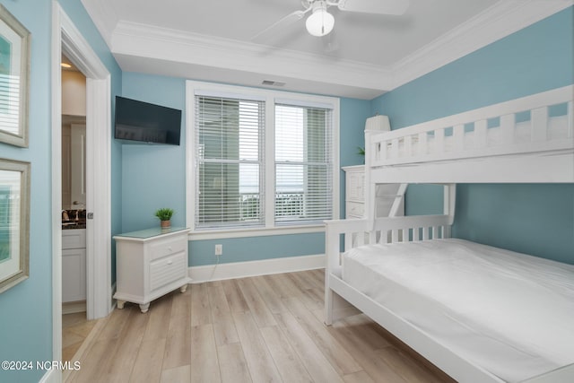 bedroom with crown molding, light hardwood / wood-style floors, and ceiling fan